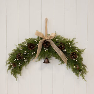 Arc Swag with White Berries, Pinecones with Bells and Bow Detail